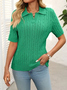Detailed view of the bright green cable-knit texture and V-neck polo collar on the knit sweater