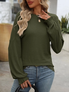 Detail view of dark green ribbed knit top featuring elastic ruffled cuffs and soft texture