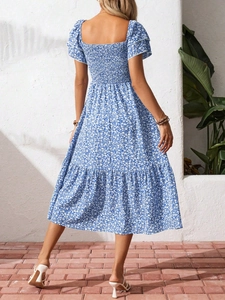 Detail view of the smocked elastic back on a blue floral puff sleeve midi dress
