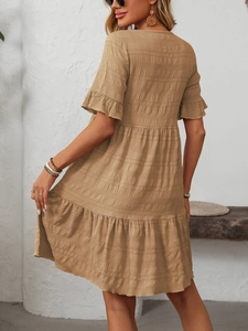 Detail of khaki pleated dress fabric texture with loose short sleeves and ruffled hem design