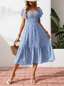 Detail of smocked bodice and square neckline on blue and white floral summer dress
