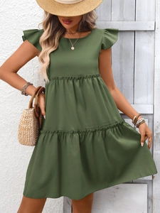 Détail d'une robe sans manches vert armée à volants et jupe à étages de style vacances d'été