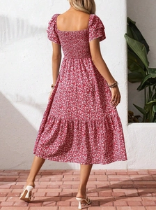 Back view of floral tiered maxi dress with smocked waist and puffed sleeves