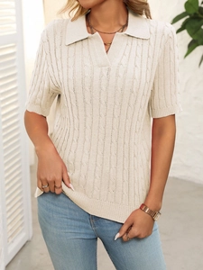 Detail of short sleeve cable knit polo sweater with V-neck in creamy beige finish