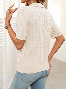 Detailed back view of a beige cable knit polo shirt featuring a classic ribbed hem and sleeves