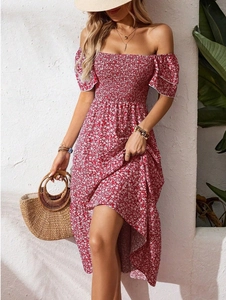 Detail showing the elastic smocking and off-shoulder design on a red floral dress