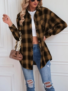 Detail view of a plaid long sleeve shirt styled with a white crop top and blue denim jeans