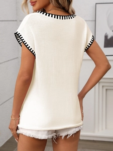 Detail of knit vest sweater with contrast stripe trim on neck and armholes