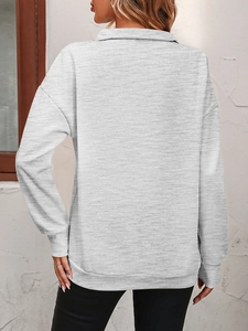 Detail view of heather grey half-zip sweatshirt with ribbed cuffs and drop shoulder