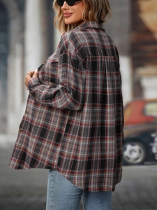 Detail view of the red plaid flannel shirt featuring a curved hem and drop shoulder cut