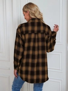 Rear view of brown and black plaid shirt with back yoke and curved hemline