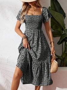 Close-up of smocked square neckline and ruffle sleeves on black floral midi dress