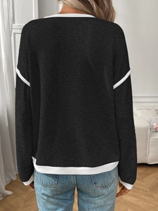 Back view of a loose-fit knit sweater with contrasting white trim and ribbed texture