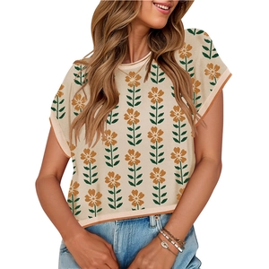 Women's knit crop top with orange floral print and contrast edging for summer