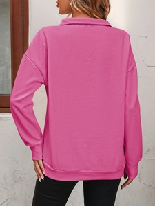 Back view of hot pink half-zip sweatshirt featuring dropped shoulders and ribbed cuffs