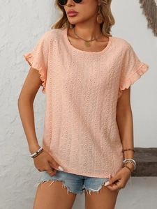 Détail de haut en broderie anglaise pêche avec manches volantées et bords festonnés