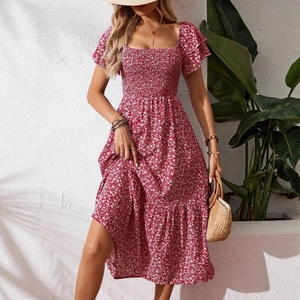 Red floral midi dress with puff sleeves and square neck in a sunny outdoor resort setting