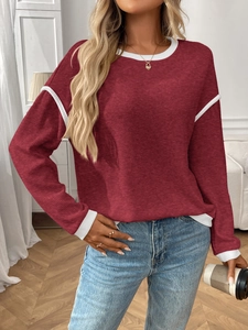 Detail of waffle knit fabric on wine red long sleeve top with white contrast stitching