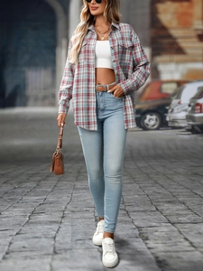 Street style view of a red and blue plaid button-down shirt paired with blue denim jeans