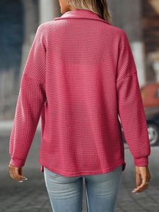 Detailed back view of magenta waffle knit shirt featuring textured fabric and relaxed fit