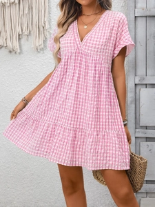 Detail of V-neck tiered gingham summer dress in pink and white with a relaxed fit