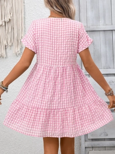 Detail view of pink and white gingham plaid tiered dress back with casual summer cut