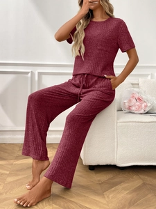 Detail of dark red ribbed lounge set with round neck top and wide-leg drawstring pants