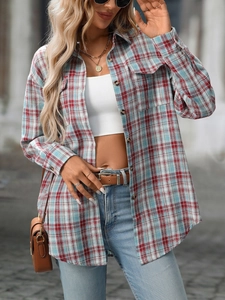 Detail view of a vintage plaid shacket with front flap pockets and classic dark buttons