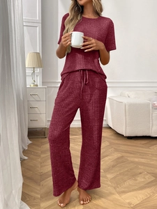Detail of ribbed knit texture on burgundy pajama set with short sleeves and wide-leg pants