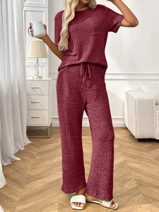 Detail of burgundy ribbed knit lounge set featuring soft texture and vertical stripe pattern