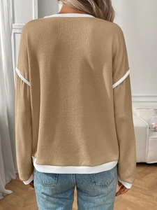 Detail of camel knit sweater with white ribbed contrast trim on shoulders and hem