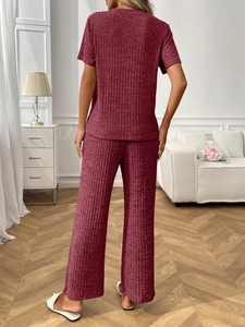 Back view of women's ribbed knit lounge set in burgundy featuring short sleeve and wide pants