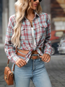 Detailed view of red and blue plaid shirt featuring flap chest pockets and buttons