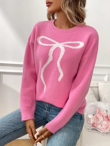 Detailed knit texture of pink long-sleeved sweater with white bow jacquard pattern