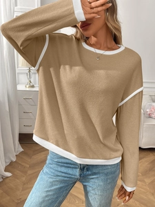 Detail of khaki ribbed knit sweater featuring contrast white stitching and round neckline