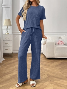 Detail of blue ribbed knit loungewear set featuring short sleeves and drawstring pants