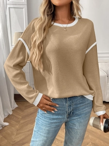 Detail shot of khaki waffle knit sweater with white contrast piping on collar and sleeves