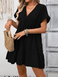 Detail of V-neck short sleeve dress with waffle texture and tiered ruffle hemline