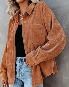 Detail of caramel corduroy shirt showing texture, classic collar, and front pocket