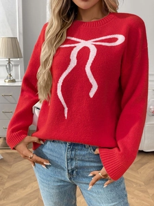 Detail of red knit sweater with pink bow jacquard pattern and classic round neck design