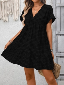 Detail of V-neck short sleeve plaid tiered dress with relaxed bohemian vacation vibe