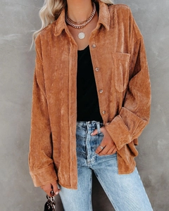 Detail shot of brown corduroy oversized shirt texture and stylish layered gold chain