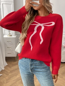Detail of red crewneck sweater featuring a pink bow jacquard pattern and long sleeves