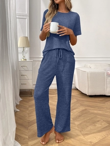 Detail of navy blue ribbed knit texture on short sleeve top and drawstring lounge pants