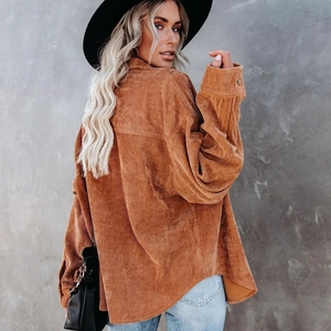 Detailed view of oversized camel corduroy shacket featuring drop shoulders and buttoned cuffs