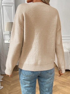 Back view of oatmeal long sleeve sweater with vintage jacquard knit pattern and bow detail