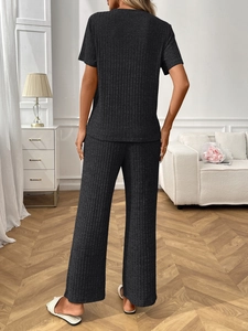 Detail of dark grey rib-knit loungewear set featuring short sleeve top and wide leg pants