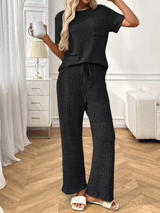 Detail of dark grey ribbed loungewear set featuring drawstring waist and soft texture