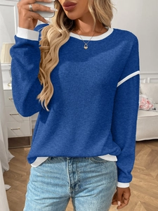 Detail of blue long sleeve knit sweater with white contrast piping and round neck design