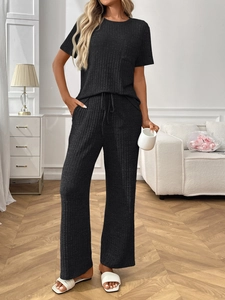 Detail of ribbed knit texture on black short sleeve lounge set with drawstring waist